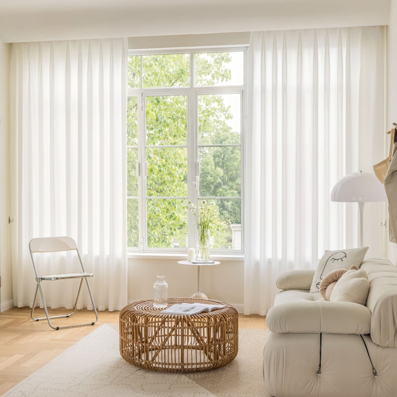 a living room with a couch, chair, table and window