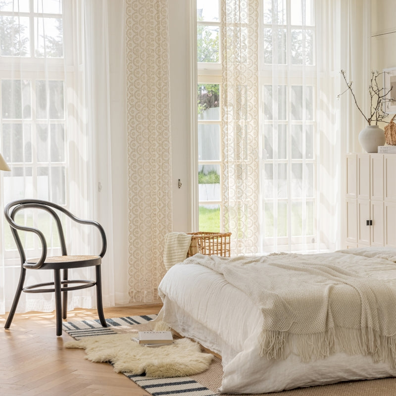 a bedroom with a bed and a chair in it