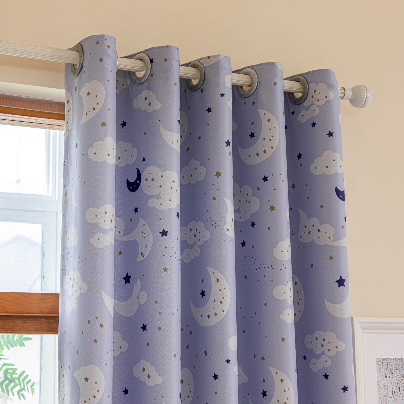a window with a blue curtain with stars and clouds on it