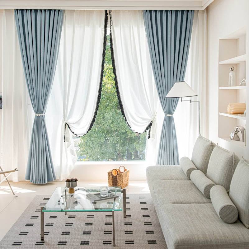 a living room filled with furniture and a large window