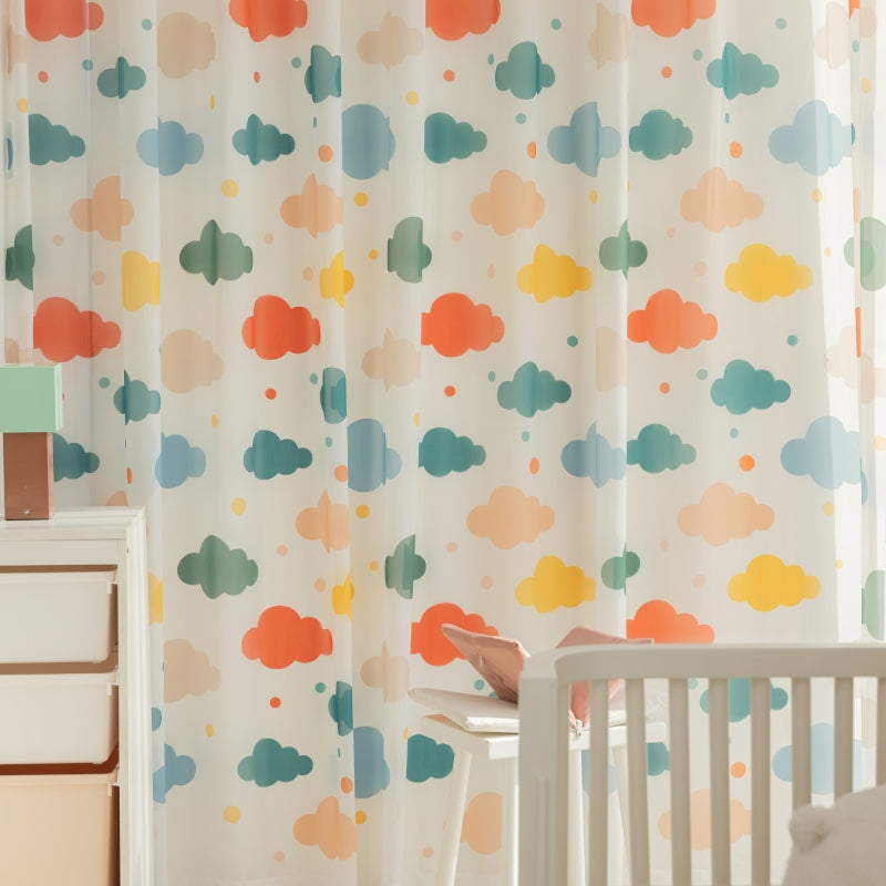 a baby's room with a crib, dresser, and curtain