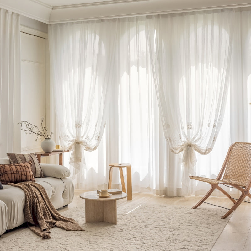 a living room with a white couch and a chair