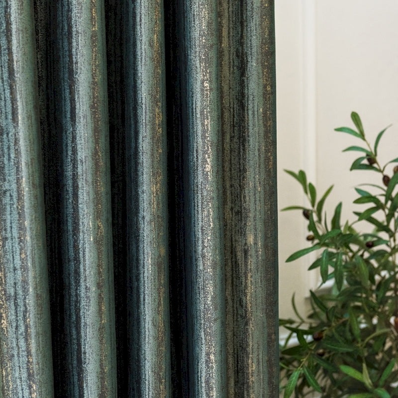 a close up of a curtain with a plant in the background