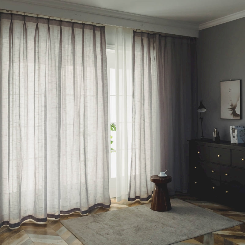 a living room with a large window and a rug
