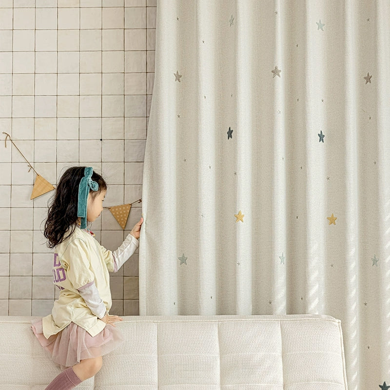 a little girl sitting on top of a white couch