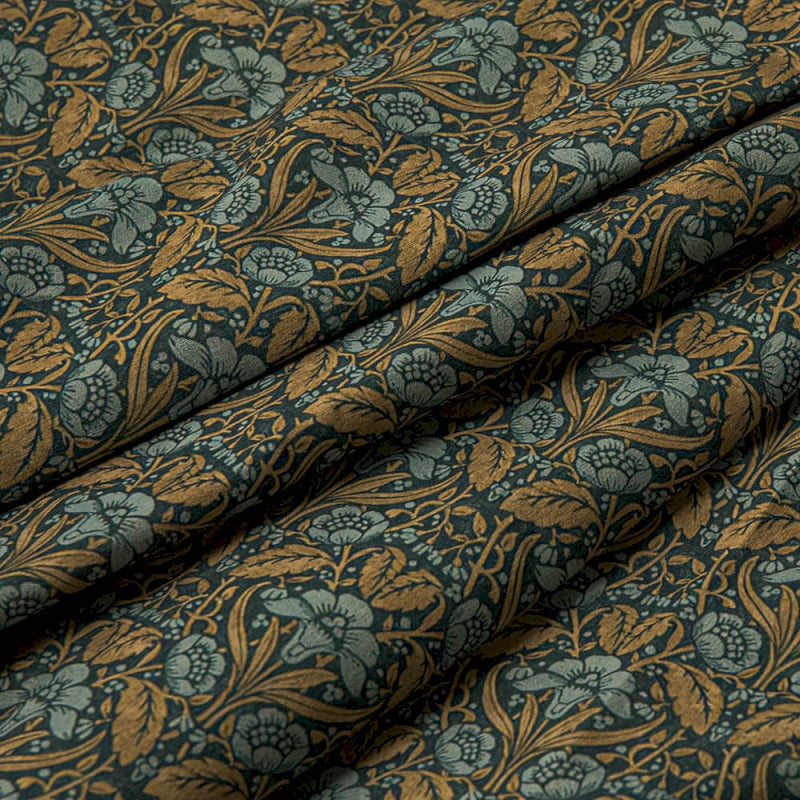 a close up of a blue and gold fabric