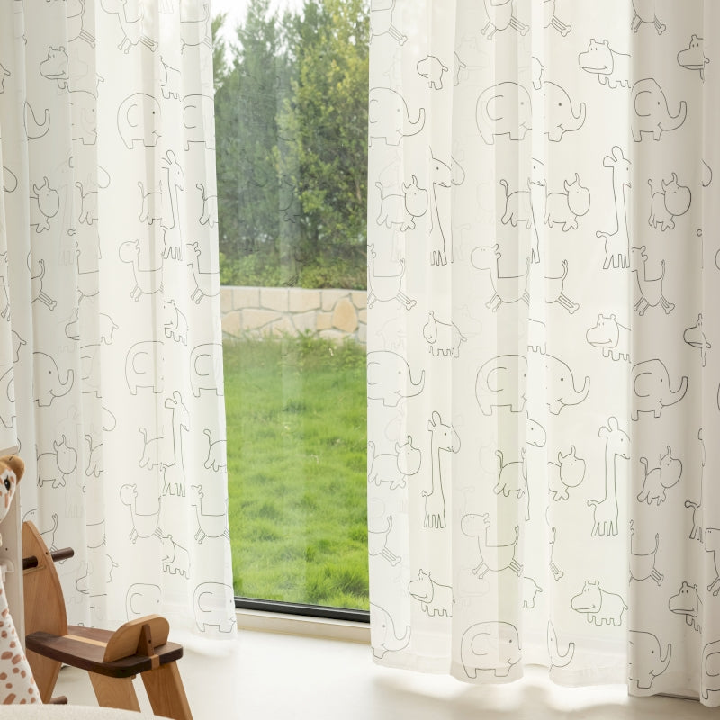 a teddy bear sitting in front of a window