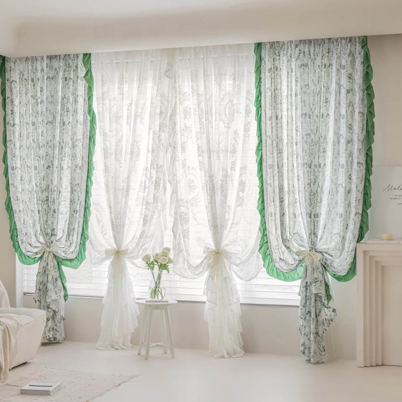 a living room with a white couch and green curtains