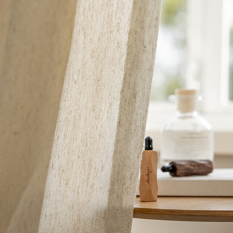 a bottle of lotion sitting next to a window