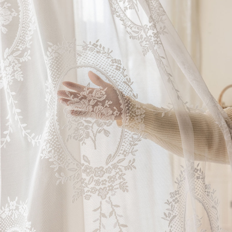 a woman's hand is seen through a sheer curtain