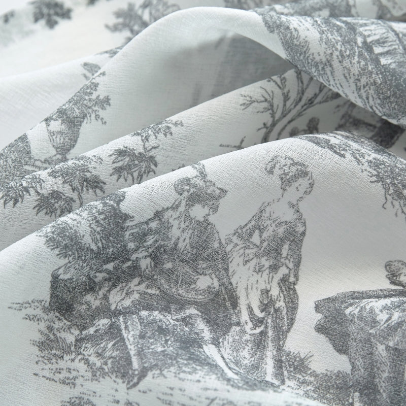 a close up of a bed sheet with a picture of animals on it