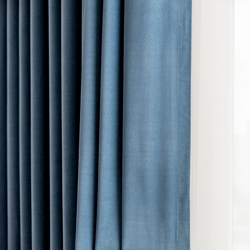 a close up of a curtain with a blue background