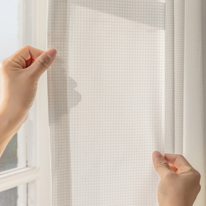 two hands are reaching up to a white curtain