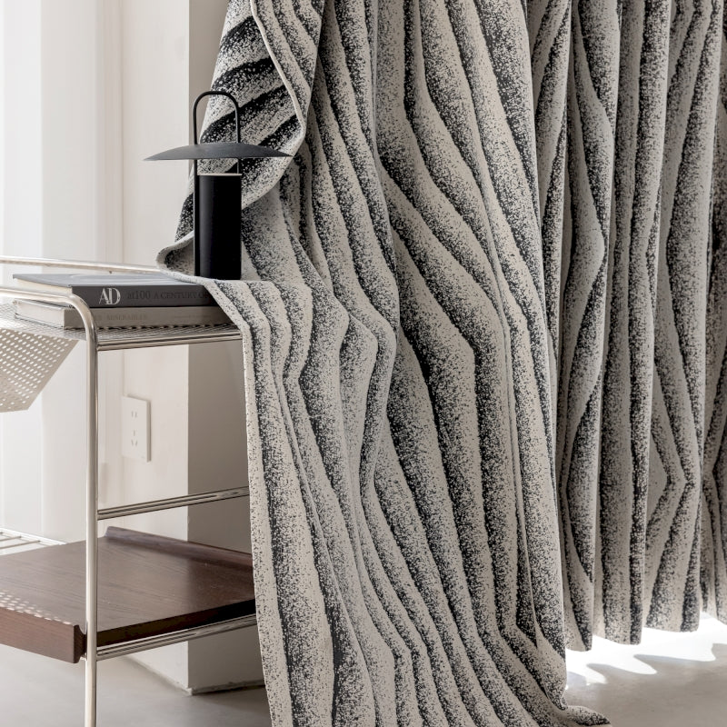 a room with a table, chair, and a curtain