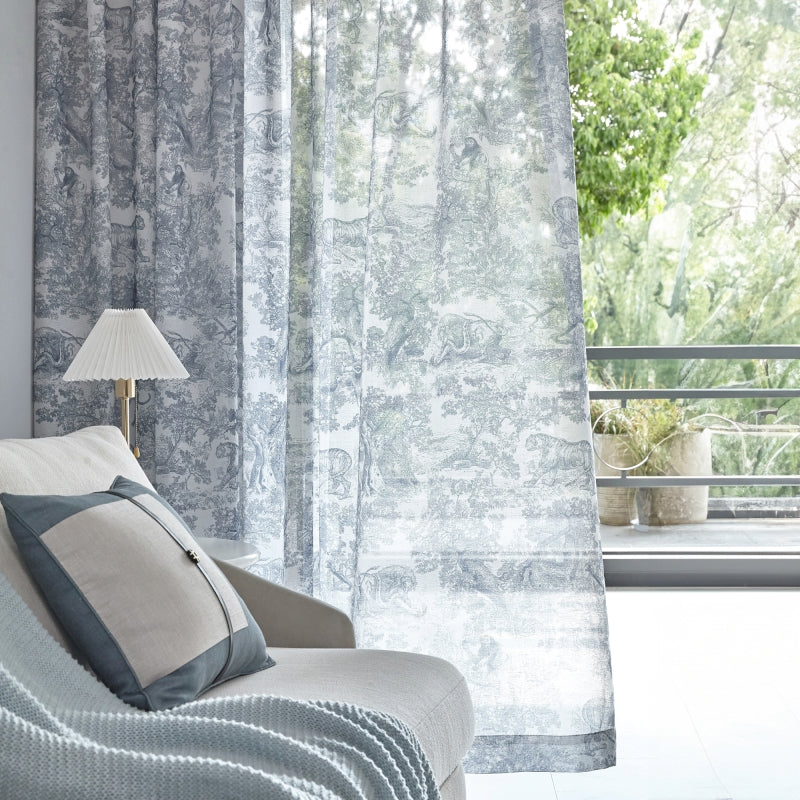 a white couch sitting next to a window covered in curtains