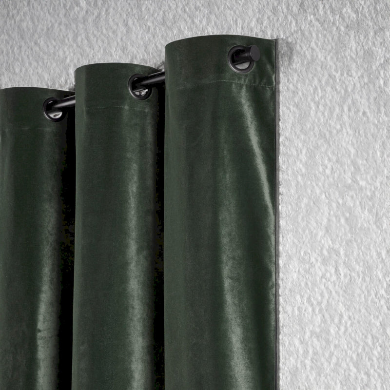 a green curtain hanging on a white wall