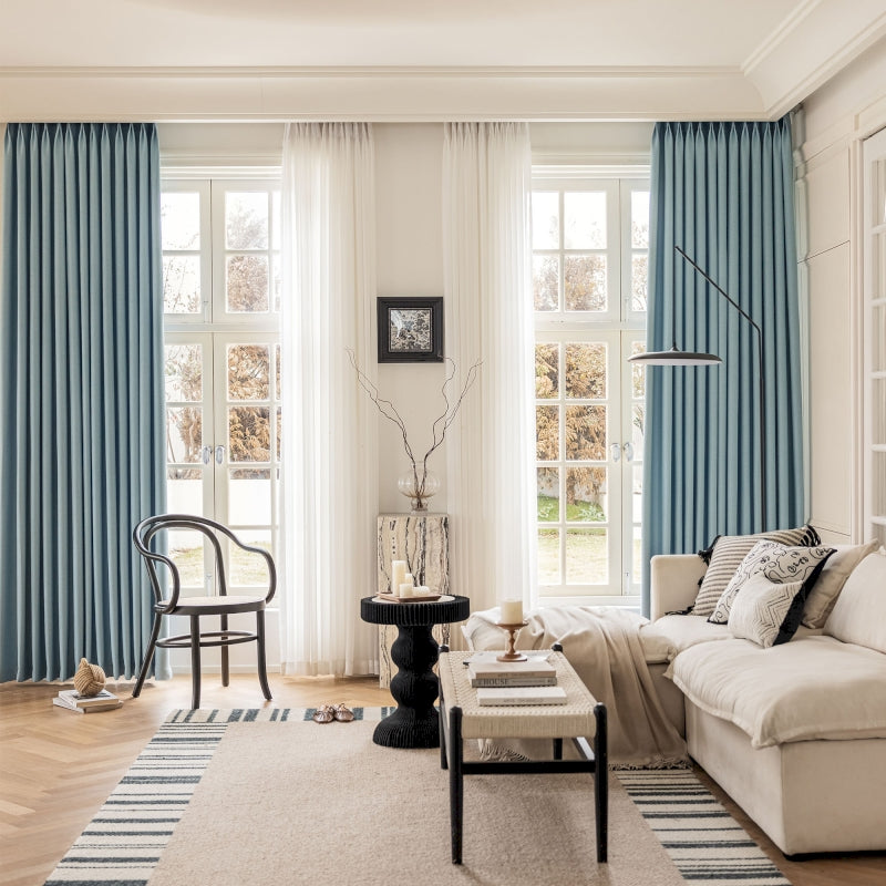 a living room filled with furniture and a large window