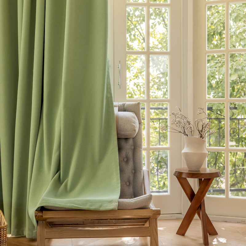 a living room with a chair and a window