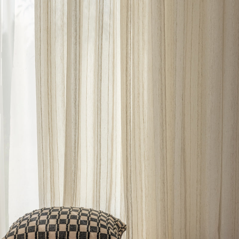 a black and white checkered pillow sitting next to a window