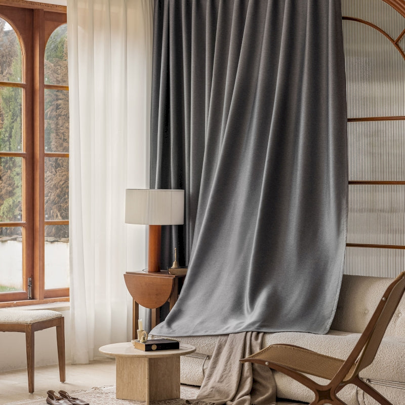 a living room with a chair and a window