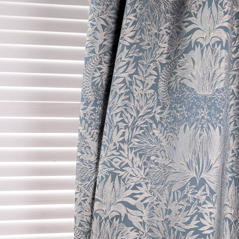 a curtain with a blue and white floral pattern