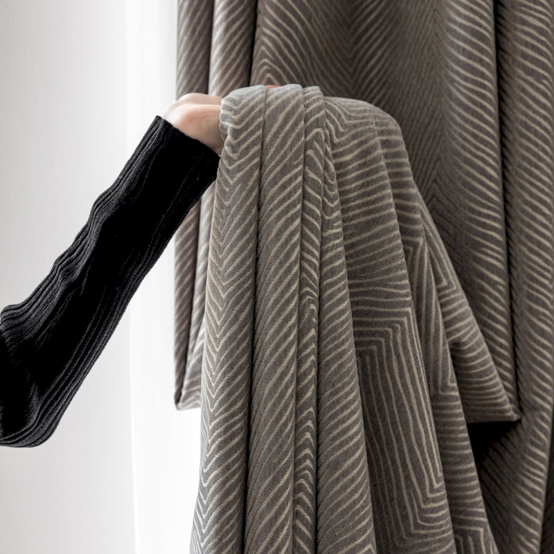 a person is holding a piece of cloth in front of a window