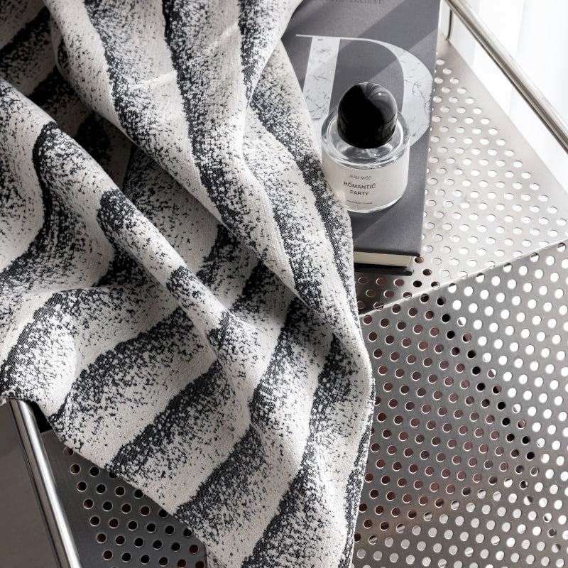 a black and white towel sitting on top of a table