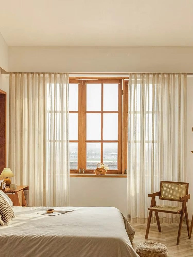 a bedroom with a bed, chair, and window