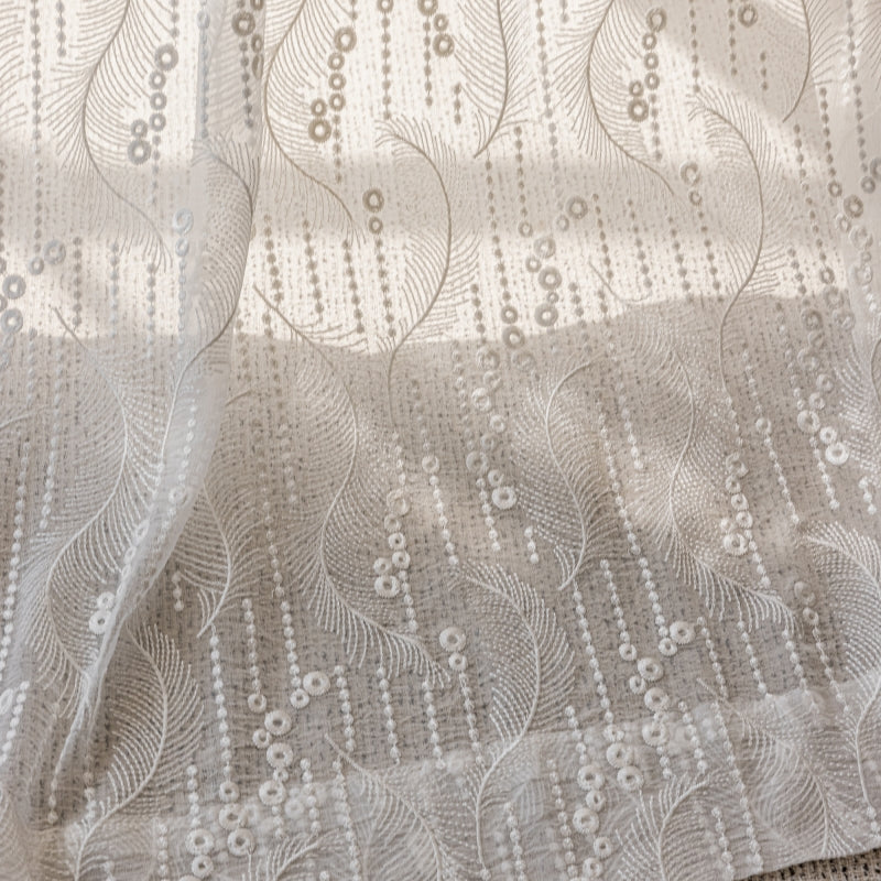 a close up of a bed with a white bedspread