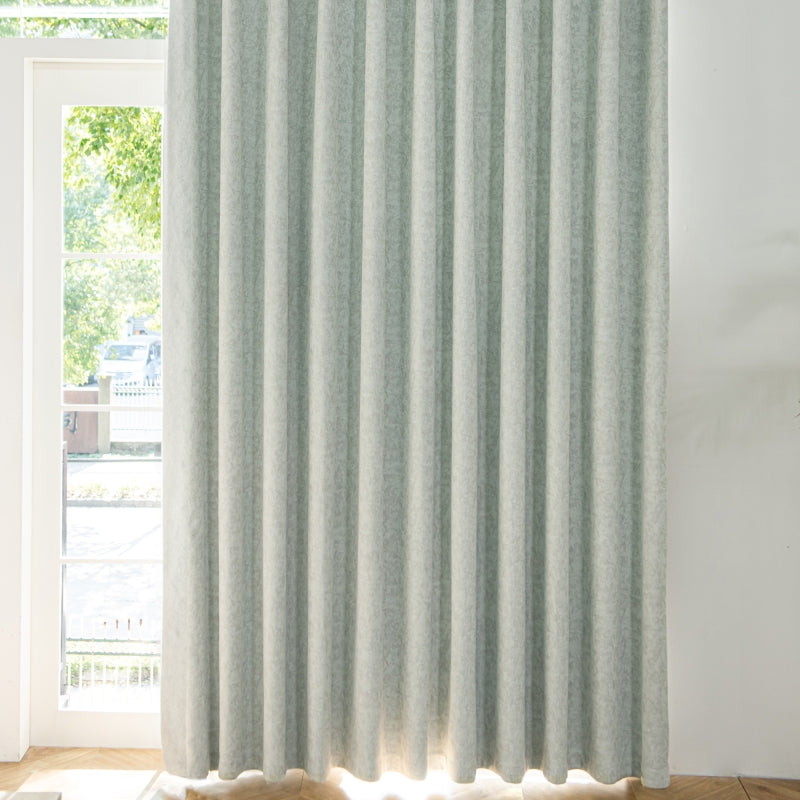 a window with a white curtain and a wooden floor