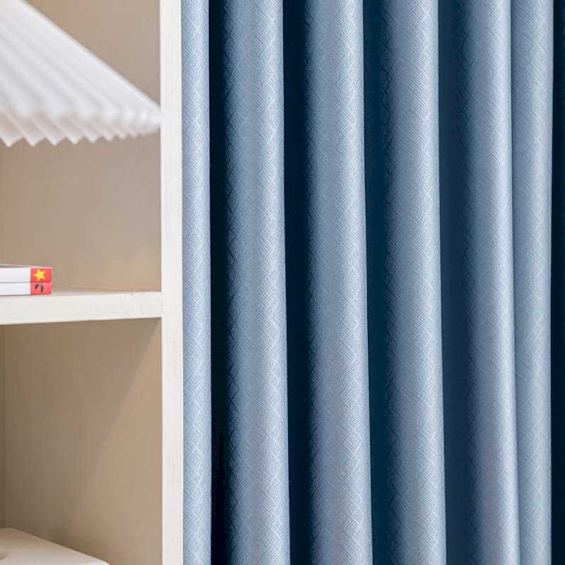 a shelf with a lamp and a blue curtain