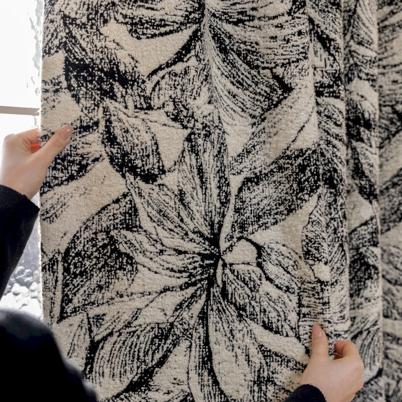 a person holding a piece of fabric in front of a window