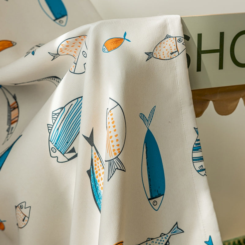 a close up of a curtain with fish on it