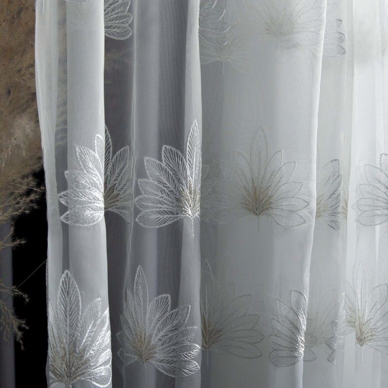 a close up of a curtain with white flowers on it