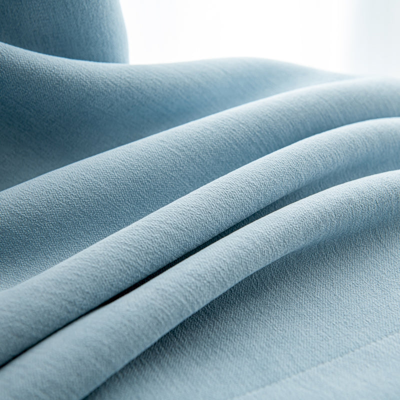 a close up of a light blue fabric