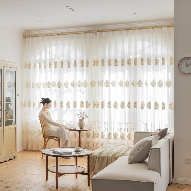 a woman sitting in a chair in front of a window