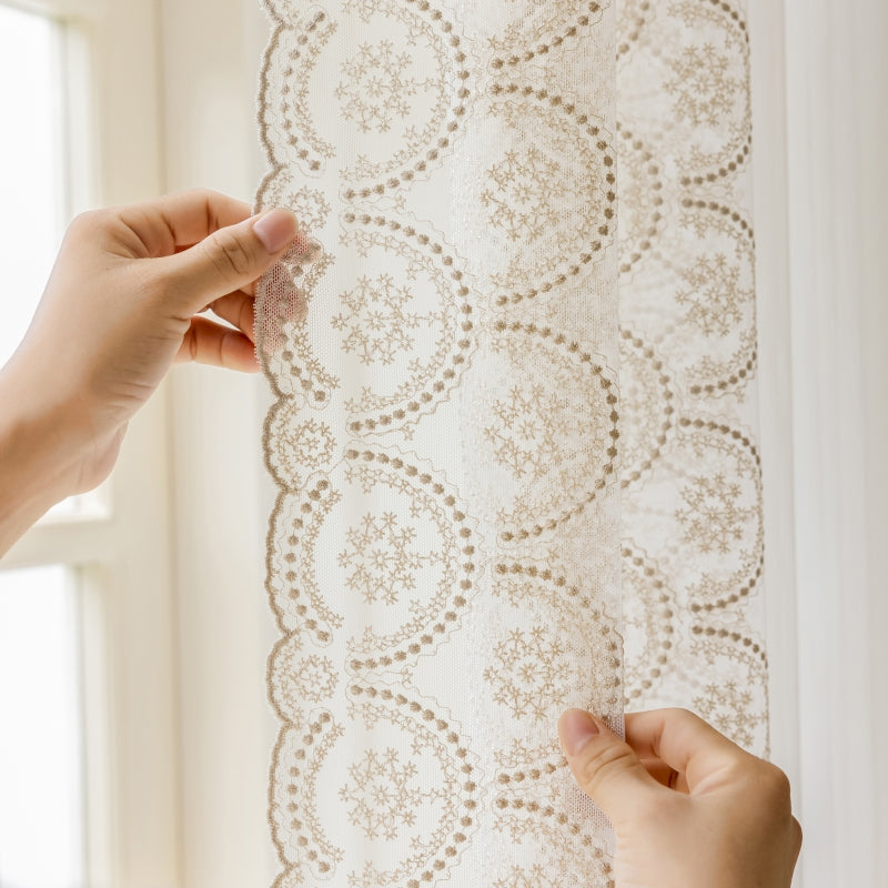 a person is working on a lace curtain