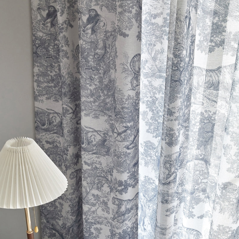 a lamp sitting next to a curtain with a bird on it