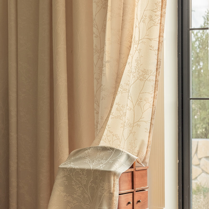 a chair sitting in front of a window next to a dresser
