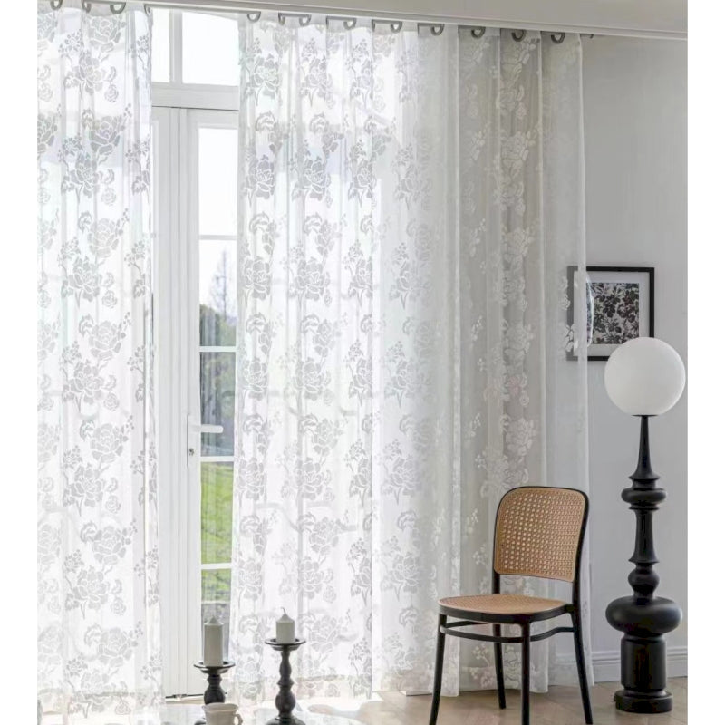 a living room with a chair and a window