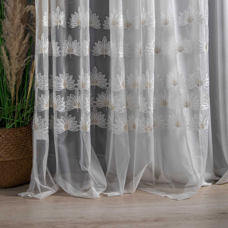 a white curtain with a flower design on it