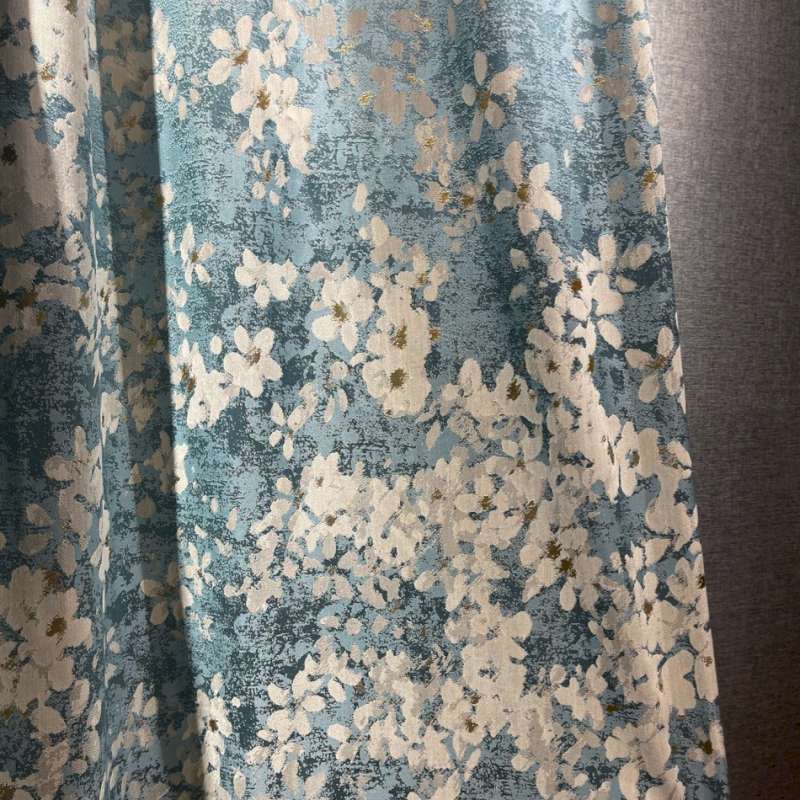 a close up of a curtain with flowers on it