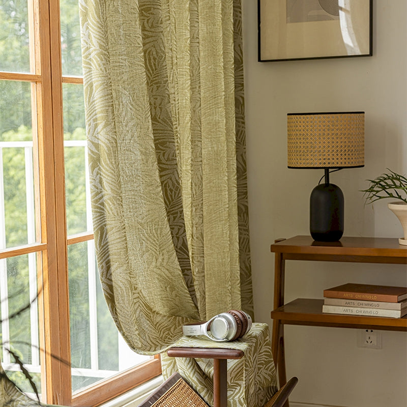 a living room with a chair and a window