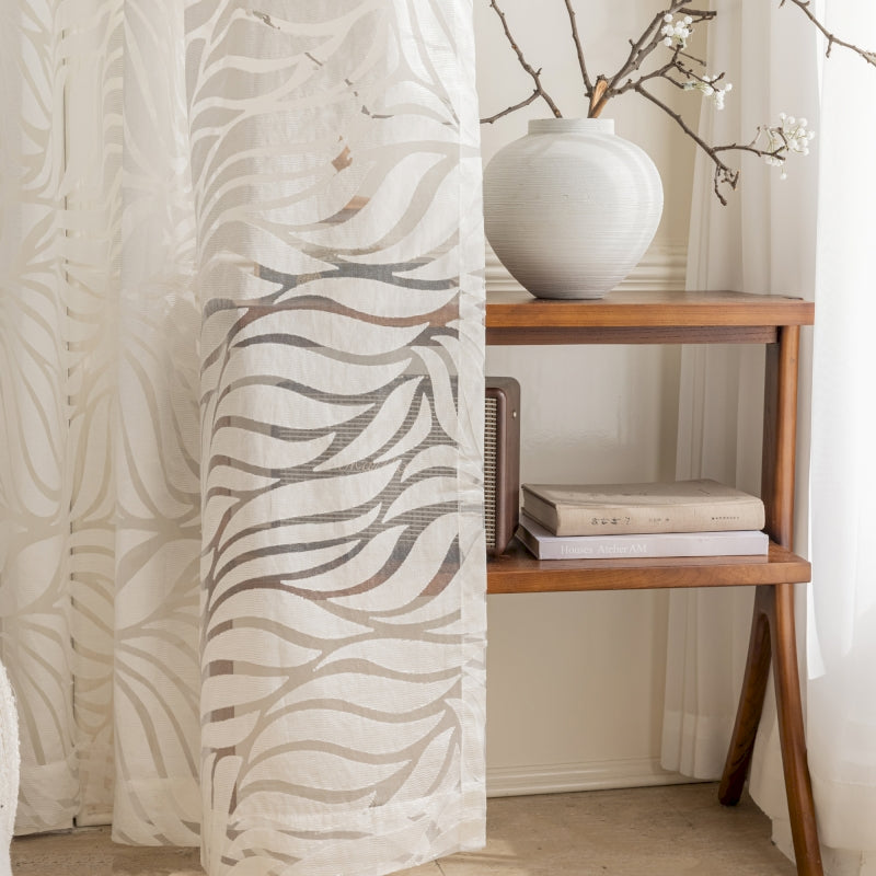 a white vase sitting on top of a wooden shelf