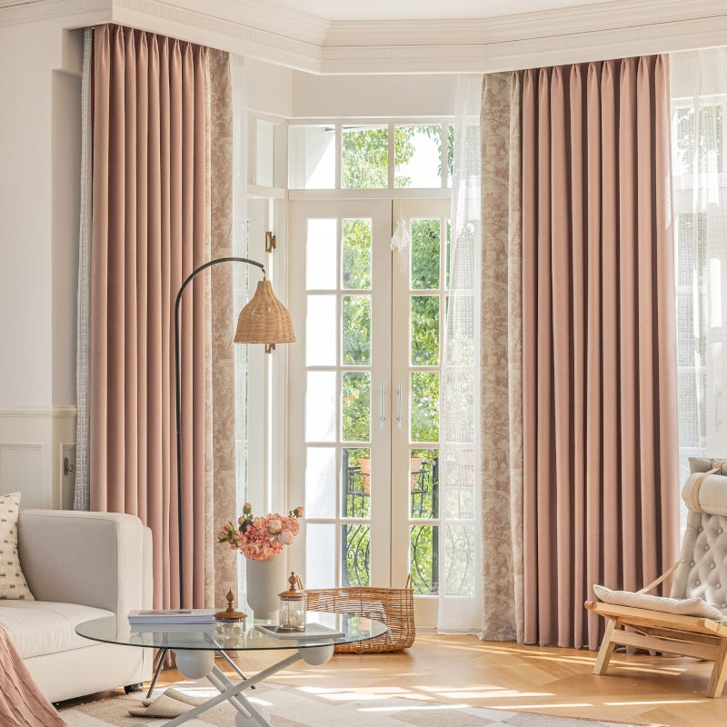 a living room filled with furniture and a window covered in pink curtains