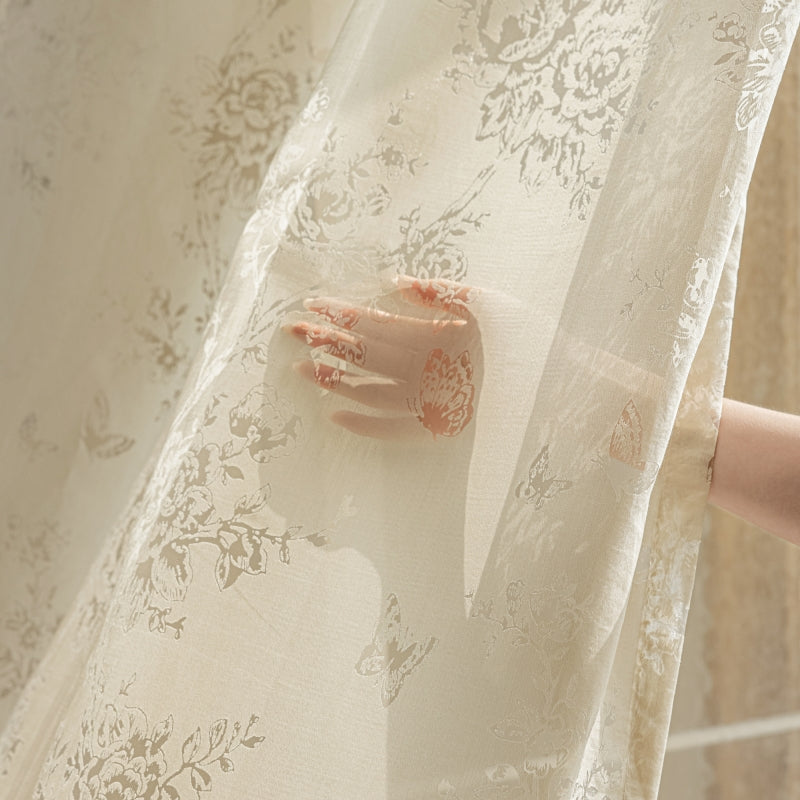 a hand is sticking out of a sheer curtain