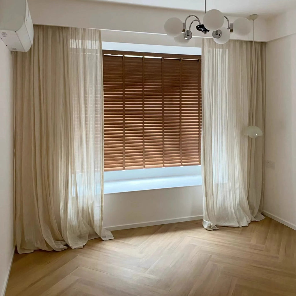 an empty room with a window and a chandelier